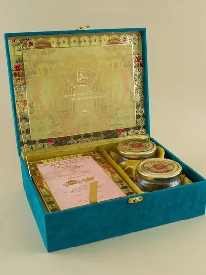 Another view of our teal velvet box, showing the detailed gold-foiled design on the inside lid and the space for two gift jars.
