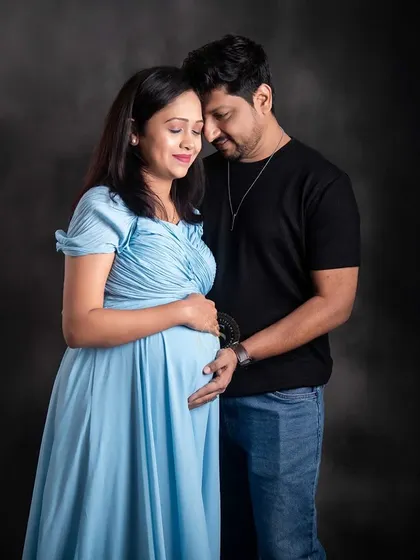 A tender moment between a couple in our studio. The soft lighting and simple grey backdrop keep the focus on their emotional connection.
