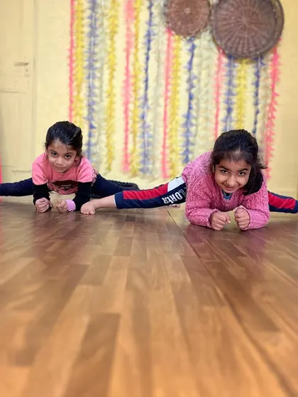 Two students showing off their amazing center splits. They are proof that with dedication, anything is possible.