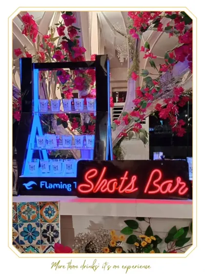 Our dedicated Shots Bar, designed to be a fun and high-energy station at any event. The neon sign and floral accents make it an inviting and exciting focal point for the party.