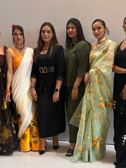 The final lineup. Standing with the models showcasing the beautifully hand-painted sarees. It's an incredible feeling to see our styling vision come to life on the runway.