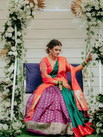The bride seated on a beautifully decorated swing, creating a dreamy and romantic portrait.