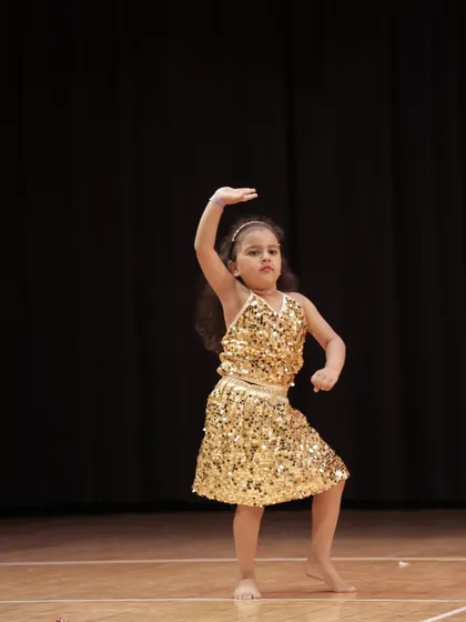 This little champ is showcasing her graceful moves. We teach even our youngest students the importance of expression.