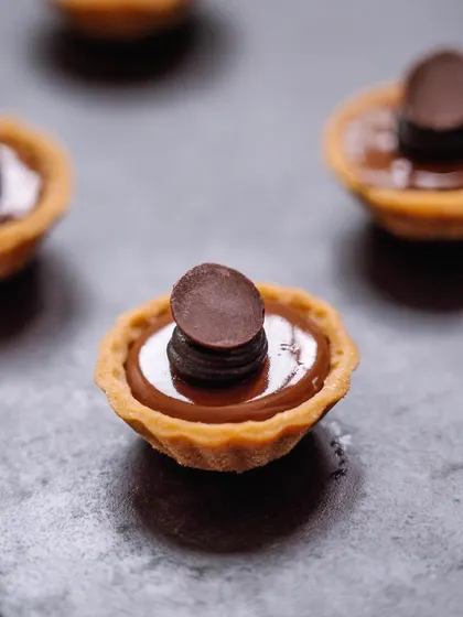 A double dark chocolate tartlet, a mini version of our classic dessert. These are perfect for when you want just a bite of something rich and decadent.