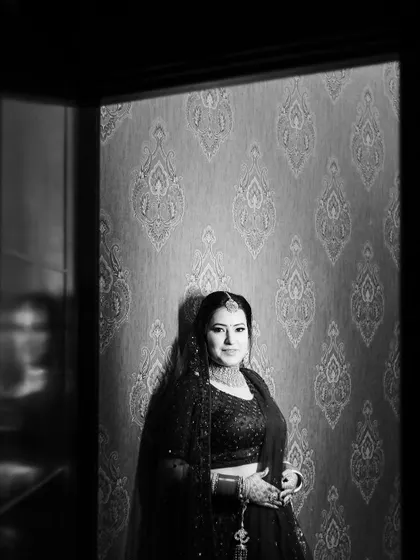 A striking black and white bridal portrait, using dramatic lighting to create a timeless and powerful image.