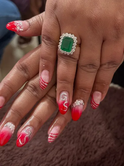 For the bride who loves a bit of drama. This custom set features red ombre tips with silver glitter stripes and initial "GS" nail art, making it super personal and unique.