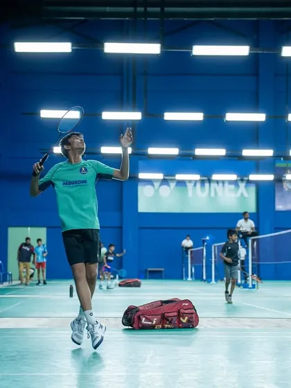 A junior player in mid-air, executing a perfect smash during the PSB Open. We provide a stage for young talent to express their skills and athleticism in a competitive setting.