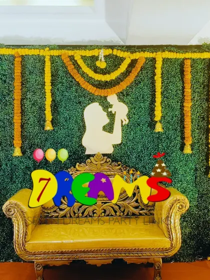 Here is a traditional baby shower stage I designed. The backdrop uses a green base with a checkerboard pattern of marigold flowers and a special golden sofa for the mother-to-be.