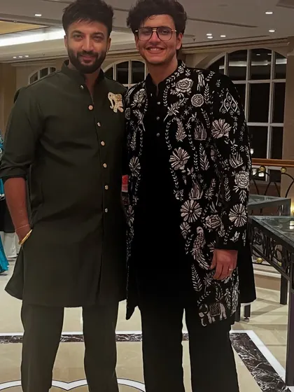 A custom black velvet sherwani with intricate floral embroidery designed for YouTuber Triggered Insaan. This piece was part of his wedding collection, showcasing a blend of traditional motifs and modern elegance.