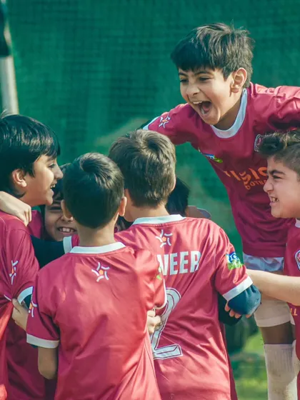 The raw passion of the game. A candid shot of our players celebrating a goal with pure, uncontainable joy.