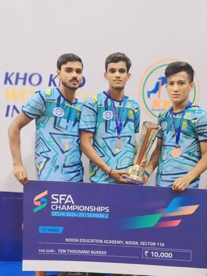 Our players with a trophy and prize money from the SFA Championships. We compete to win.