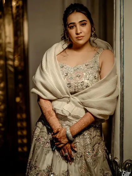 A stunning bridal look I styled, as featured by WeddingSutra. This bride wears a beautiful silver and pink lehenga with a unique pleated stole.