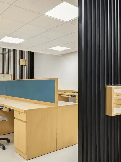 This admin office space is designed with clean lines and a neutral palette to foster efficiency and well-being for healthcare providers. The open plan is professional and inviting, with a minimalist reception desk.