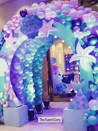 A spectacular underwater entrance for a mermaid-themed party. The balloon arch in shades of purple and teal creates a magical tunnel for guests to walk through.