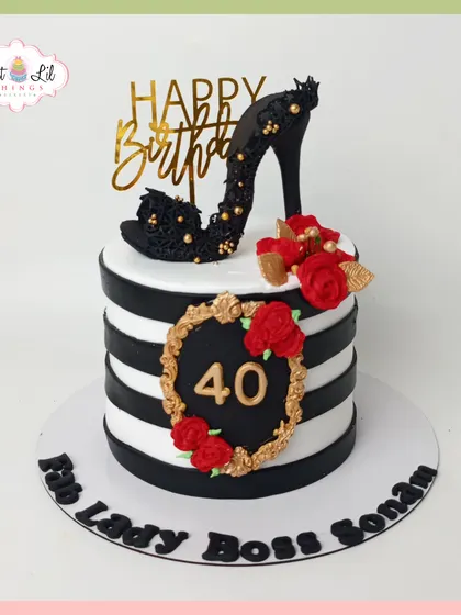 Celebrate a milestone with glamour and style. This "Boss Lady" cake for a 40th birthday features bold black and white stripes, a handcrafted edible stiletto, and elegant red roses, perfect for a chic and fabulous celebration.
