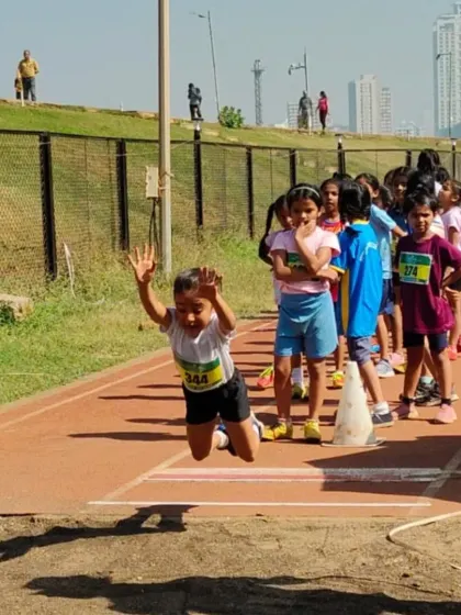 A young athlete soars through the air during the long jump event at the PDP Athletics Championships. The focus and determination on her face capture the competitive spirit of the day.