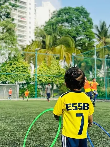 A young player looks on, ready to join the fun. We create an inclusive atmosphere where every child feels part of the team.