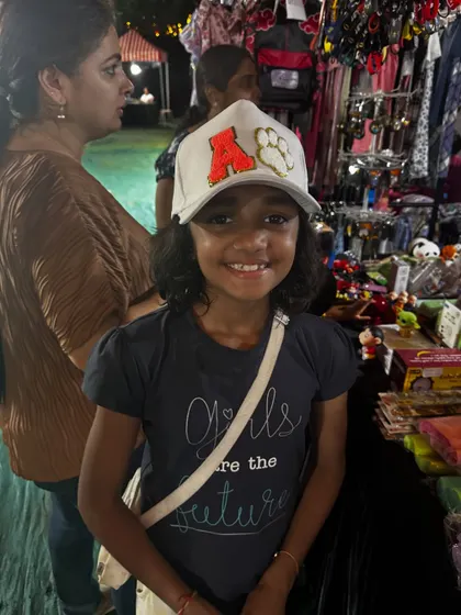 This young girl looks so happy with her new personalized cap from my live event stall.