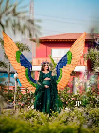 This is one of my absolute favorite pieces for a truly magical maternity photoshoot. The emerald green gown comes with a dramatic feathered overlay and these stunning, colorful angel wings to create a one-of-a-kind look. It’s perfect for mamas who want to feel like a goddess.