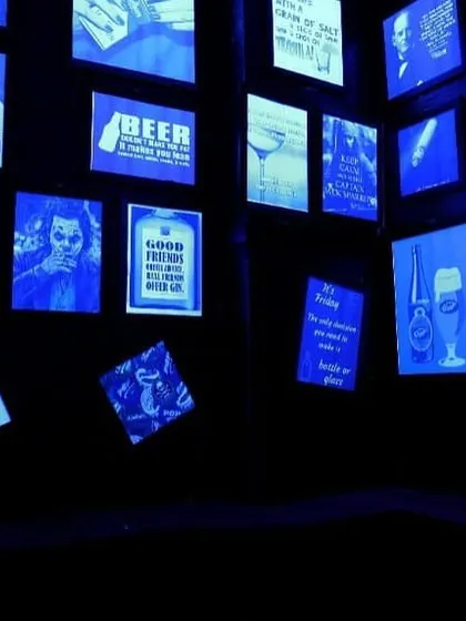 A creative feature wall at Harmony Inn, where our lighting system uses blue light to make the artwork pop. This shows how automation can be used for dynamic decorative effects in commercial interiors.