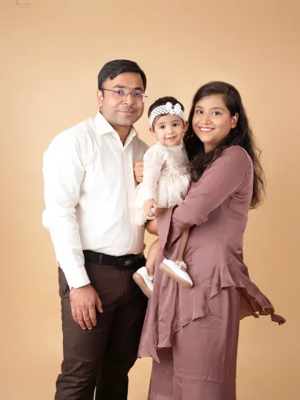 A happy family of three, smiling together. Our goal is to capture the genuine love and connection you share.