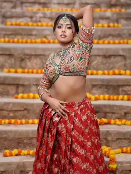 A beautiful shot from a creative photoshoot. The makeup is soft and glowing, perfectly complementing the traditional yet modern lehenga.