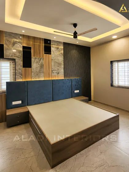 A bedroom design that plays with textures and materials. The back wall features a combination of marble, wood, and dark textured panels, creating a rich and layered look.