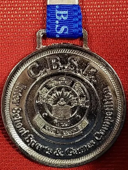 A close-up of a CBSE Inter-School Sports & Games Competition medal.