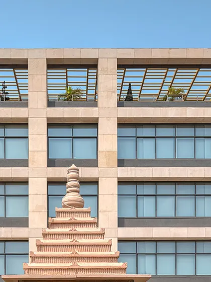 A detail shot of the Laurus Labs facade, showing how it interacts with traditional architectural elements, blending corporate modernity with local context.