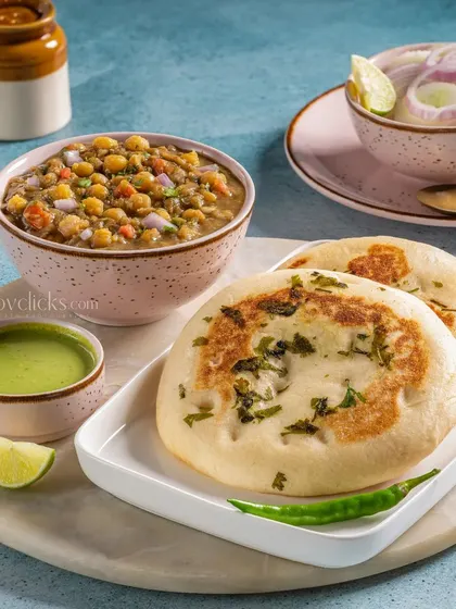 A plate of Matar Kulcha, a popular North Indian street food, served with a side of chutney and salad.