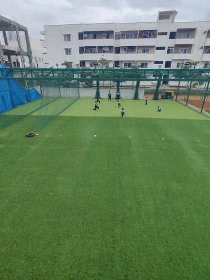 A wide view of our training facility, showcasing the nets and open ground space. We have the infrastructure to support comprehensive training programs.