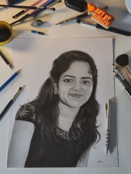 A finished portrait of a young woman, with my tools laid out to give a sense of the creative process.