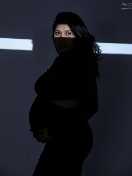 Using a projector to cast a sliver of light. This creative lighting technique creates a dramatic and mysterious silhouette that is truly one of a kind.