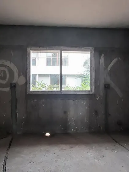 A raw, untouched kitchen space during the early stages of renovation.