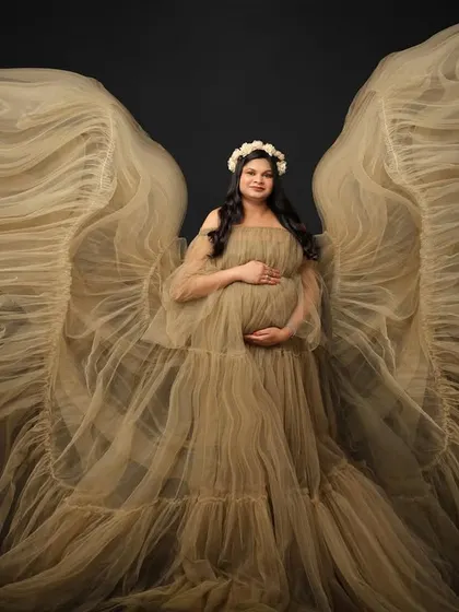There is something truly angelic about creating life. Using a beautiful tulle gown to create ethereal wings, we celebrate the miracle you are carrying with this fine art maternity portrait.
