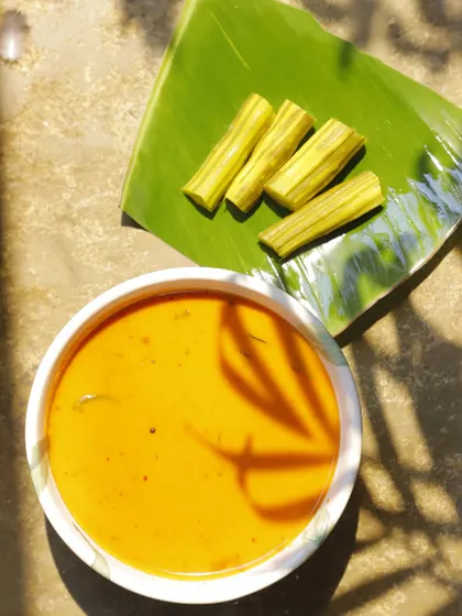 My Muringakka Manga Ozhichukootan, a drumstick and raw mango curry. This dish is guided by instinct and memory, balancing the sharpness of the mango with the earthy depth of the drumsticks in a creamy coconut base.