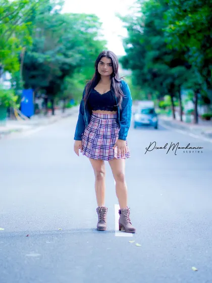 This look is all about youthful energy. The plaid skirt and boots against a simple urban wall create a clean, stylish portrait that's perfect for social media profiles.
