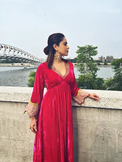Nushrratt Bharuccha in a vibrant pink velvet suit. The rich fabric and color make it a perfect choice for a winter wedding or festive event.