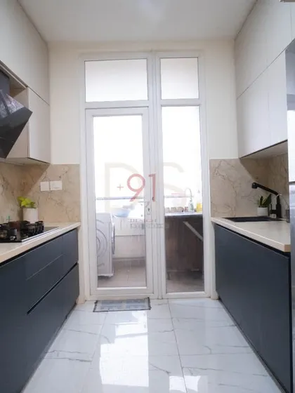 A sleek parallel kitchen with handle-less cabinets in a deep blue and white, creating a sophisticated and modern look.