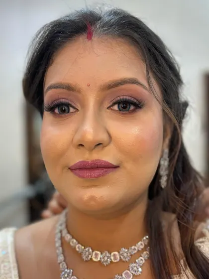 A direct, confident look from the client, happy with her transformation.