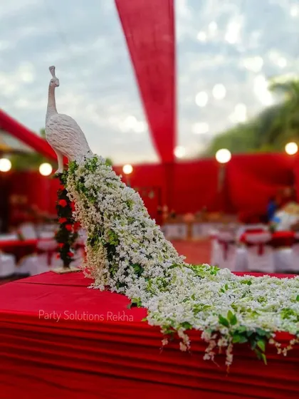 A close-up of the majestic white peacock sculpture. Its tail, crafted from a cascade of fresh white flowers, is a testament to the intricate and artistic details I love to create.