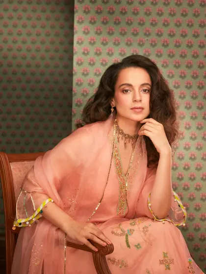 Kangana seated, looking regal in this peach ensemble. The combination of the soft color and traditional jewelry is simply timeless.