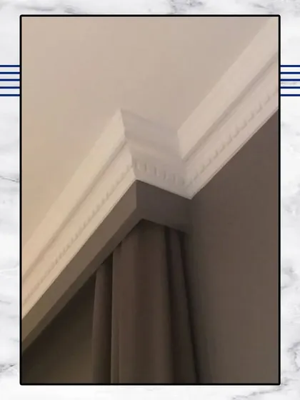 A close-up of our cornice and crown moulding work. This intricate detailing along the ceiling is a hallmark of classical design and adds a layer of sophistication to any room.
