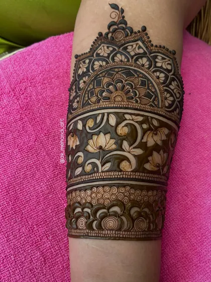 A close-up of the upper portion of the arm design, featuring a beautiful lotus and floral band.