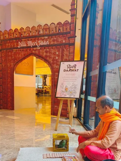 A life-sized cutout of a historic Delhi gate with "Dilli Meri Jaan" signage, creating a grand entrance for the Delhi-6 food festival. We even included live elements like a fortune-telling parrot to make the experience more interactive.