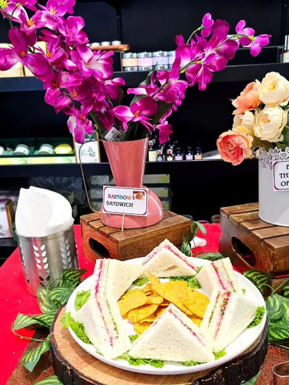 A small and elegant hi-tea setup for a brand launch in a Namma Bengaluru shopping mall. This display includes rainbow sandwiches and a station to "Enjoy the Taste of Chaat."