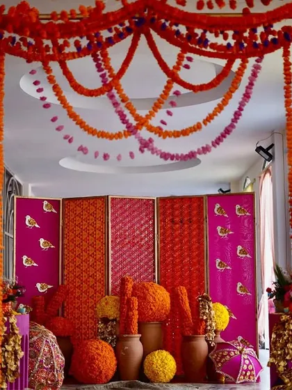 A closer view of the Phulkari entrance, highlighting the layers of marigold garlands and the richly textured and patterned backdrops that define this traditional Punjabi theme.