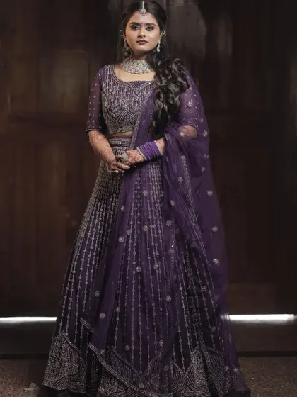 For a different wedding event, we chose this elegant purple lehenga. This demonstrates how I style for the entire wedding celebration, creating distinct yet cohesive looks for functions like the Sangeet or Reception.