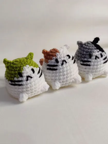 Three of the mini cat plushies together.