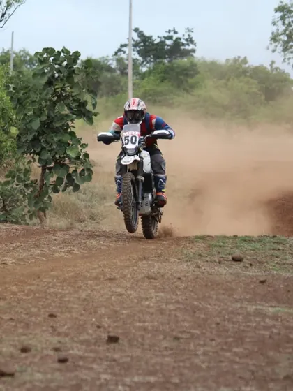 Our coach Pradeep demonstrates his off-road prowess, getting air on a dirt bike during a rally. His experience spans multiple formats, from circuit racing to the rugged stages of rally championships.